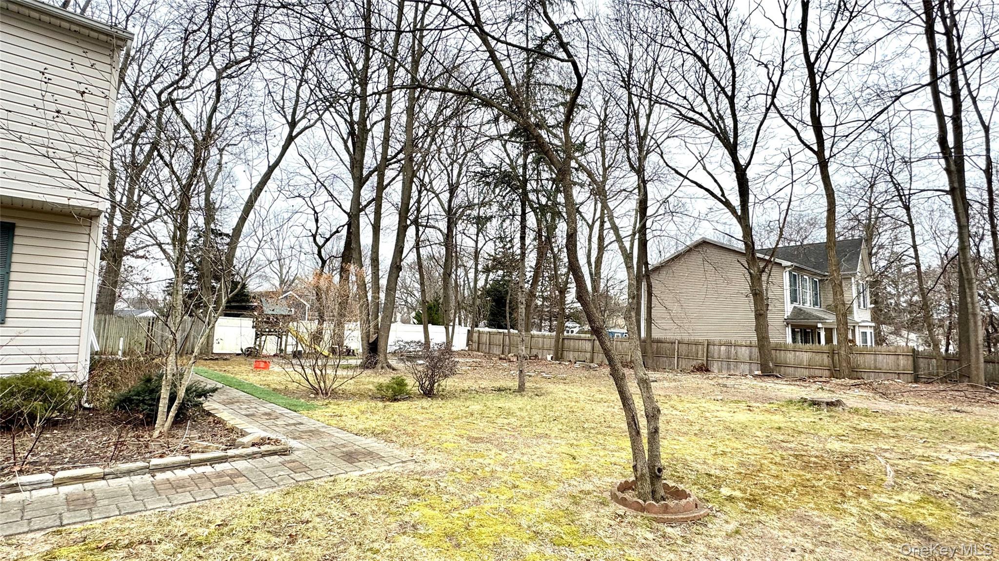 61 Gould Road Centereach, NY 11720 - Photo 21 of 22 a view of a house with snow on the background