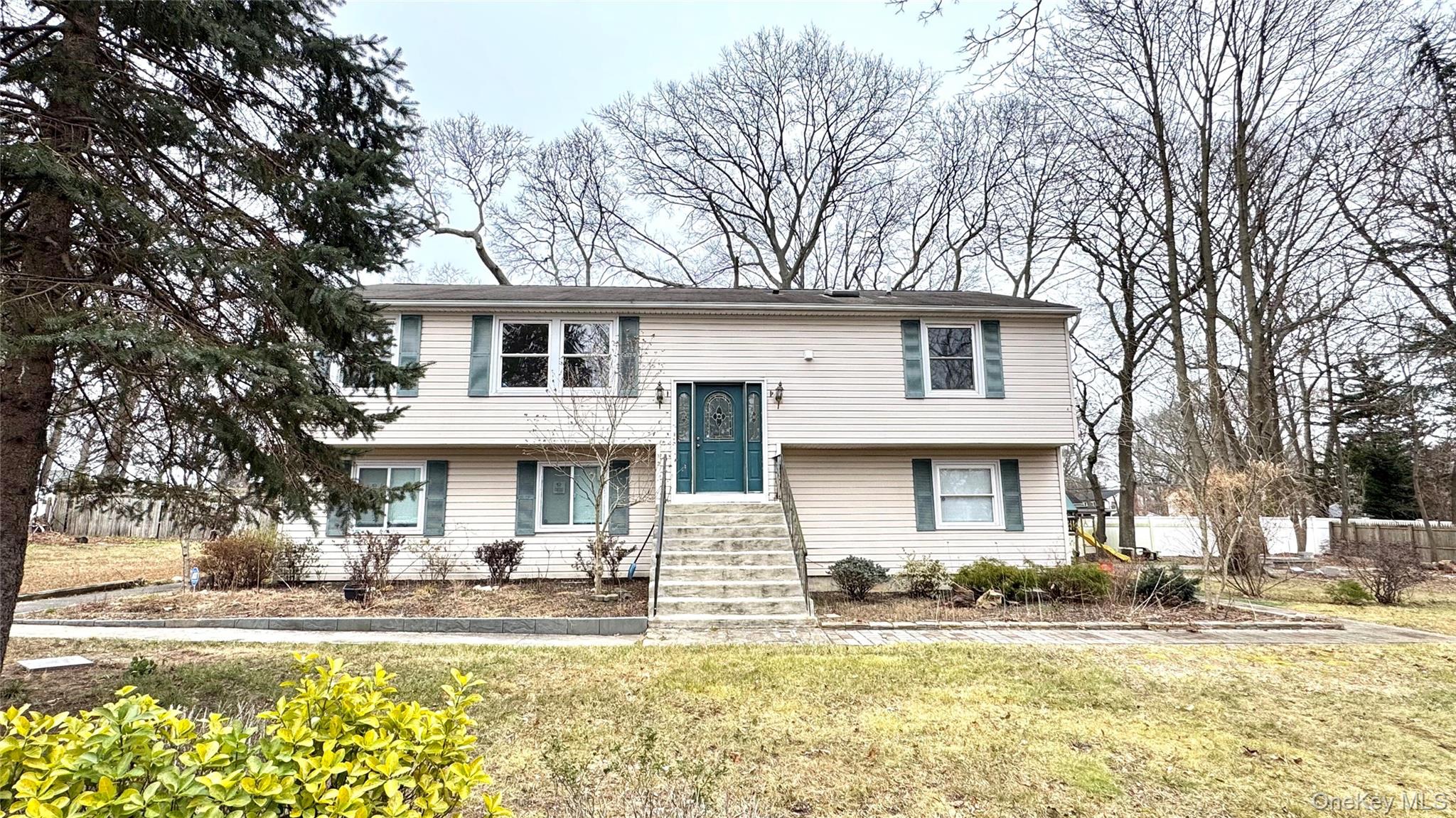 61 Gould Road Centereach, NY 11720 - Photo 22 of 22 a front view of a house with swimming pool and porch with furniture
