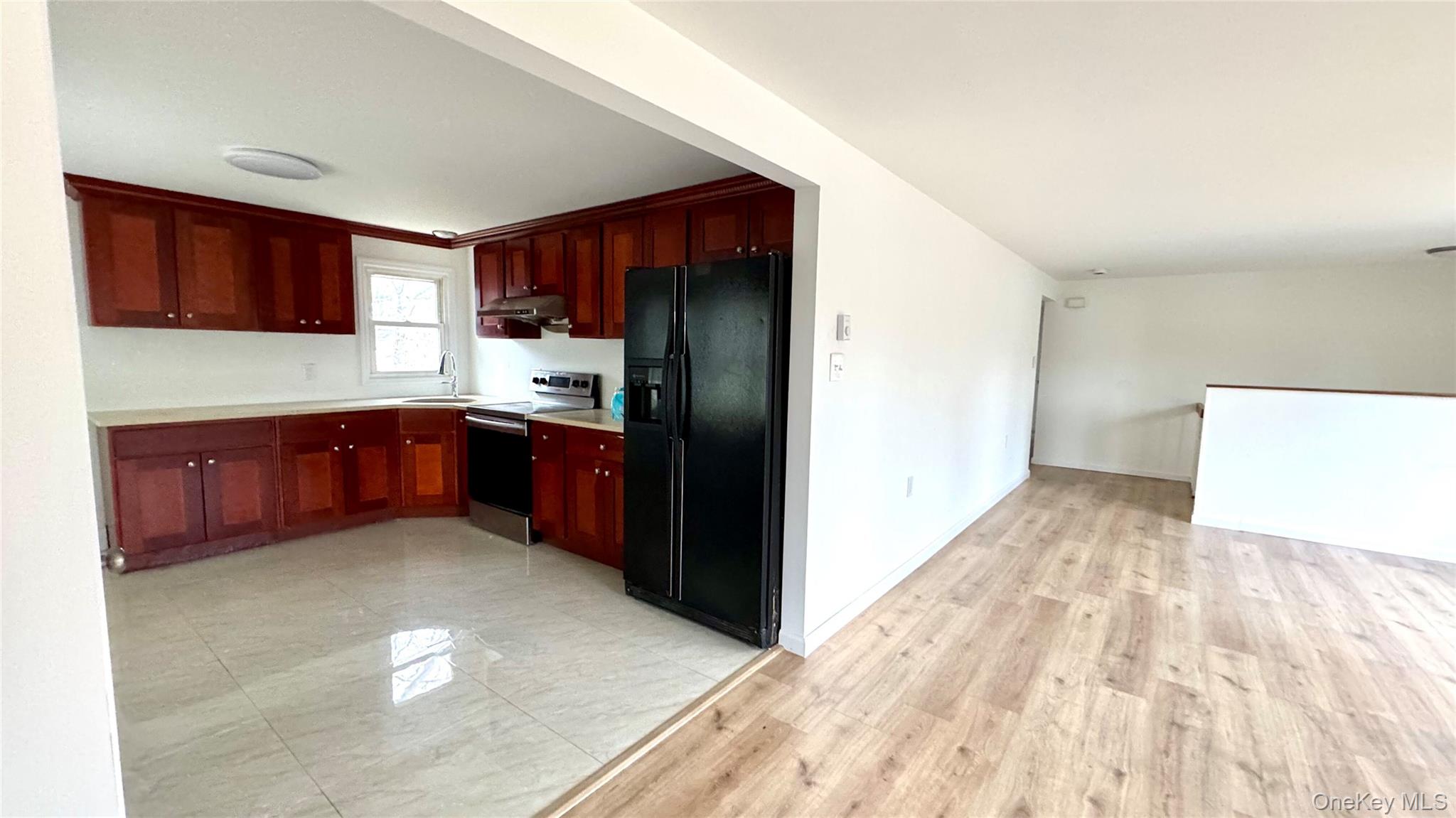 61 Gould Road Centereach, NY 11720 - Photo 6 of 22 a kitchen with stainless steel appliances granite countertop a refrigerator and a sink