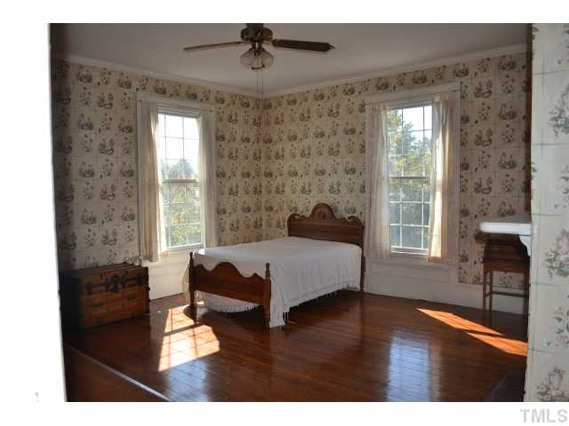 3785 Dabney Road Henderson, NC 27537 - Photo 4 of 13 a spacious bedroom with a bed and a window