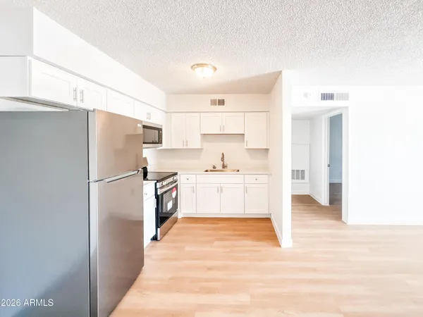 a kitchen with stainless steel appliances a refrigerator and a stove