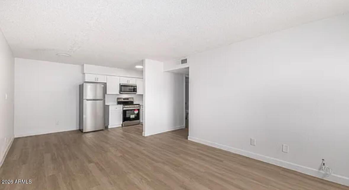 2615 East Greenway Road, Unit 21 Phoenix, AZ 85032 - Photo 8 of 19 a view of kitchen with wooden floor