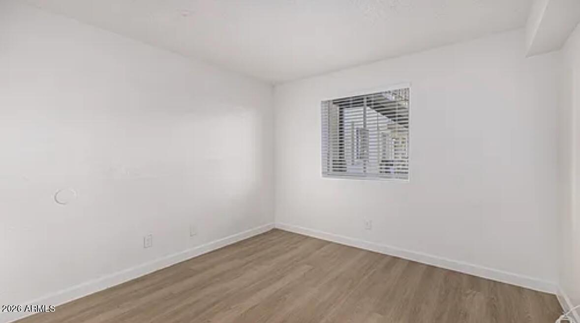 2615 East Greenway Road, Unit 21 Phoenix, AZ 85032 - Photo 9 of 19 wooden floor in an empty room