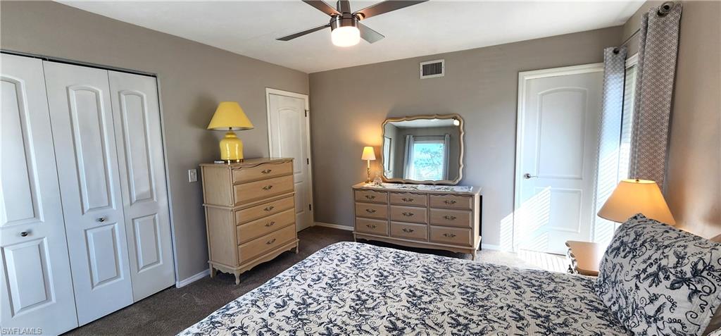 75 Georgetown Boulevard, Unit 75 Naples, FL 34112 - Photo 13 of 28 Carpeted bedroom featuring a walk-in closet and ceiling fan