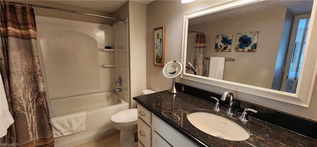 75 Georgetown Boulevard, Unit 75 Naples, FL 34112 - Photo 18 of 28 Full bathroom featuring tile patterned flooring, vanity, toilet, and shower / tub combo