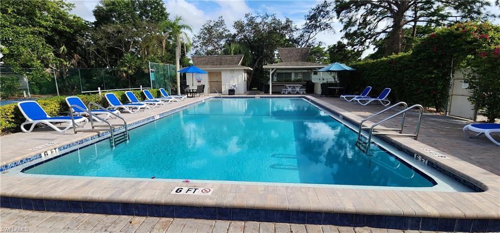 75 Georgetown Boulevard, Unit 75 Naples, FL 34112 - Photo 23 of 28 View of pool with a patio area and an Tiki hut