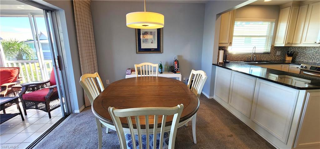 75 Georgetown Boulevard, Unit 75 Naples, FL 34112 - Photo 7 of 28 Dining room with carpet floors