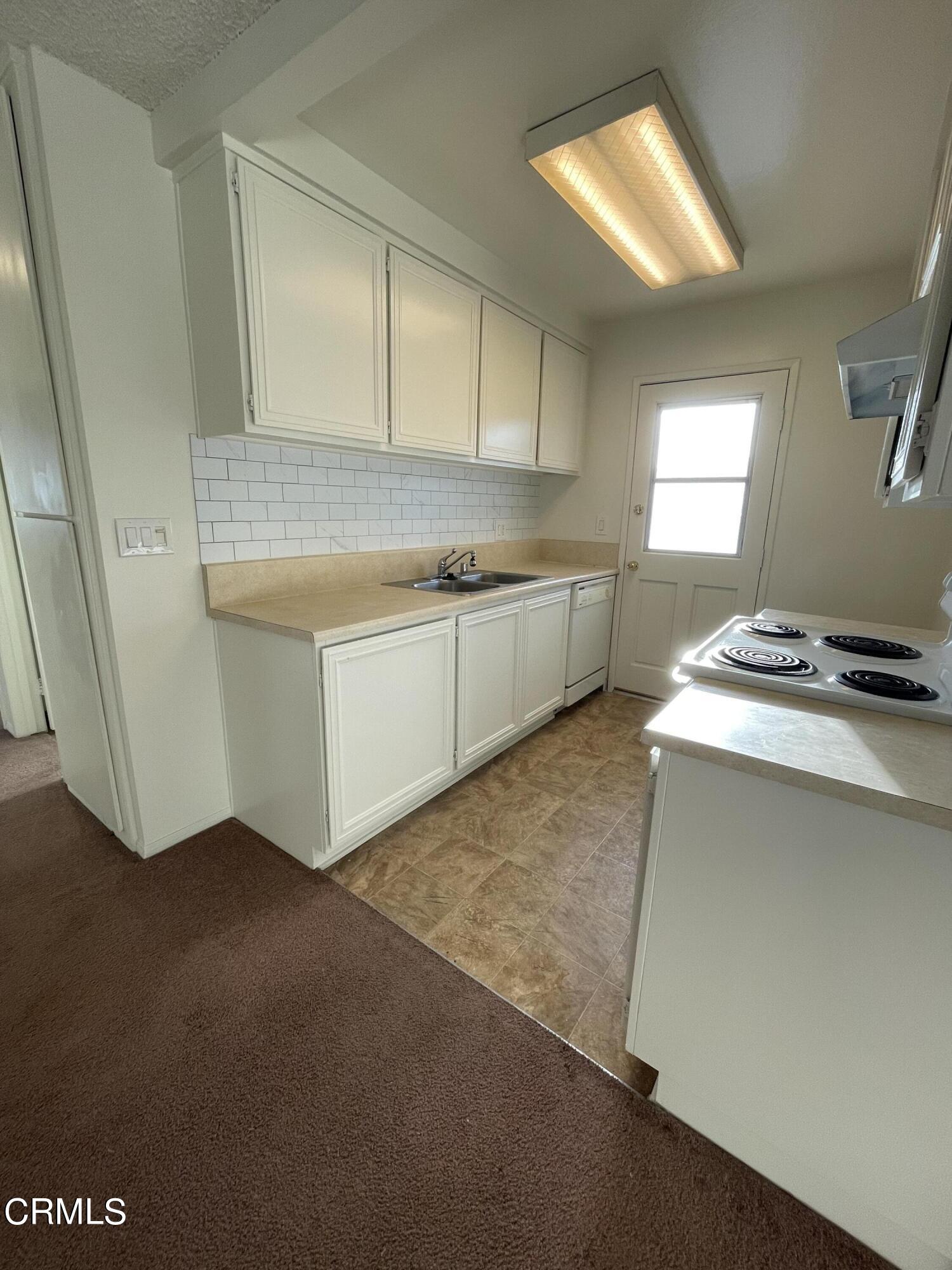 1103 Bryce Way Ventura, CA 93003 - Photo 3 of 8 a kitchen with a sink cabinets and a window