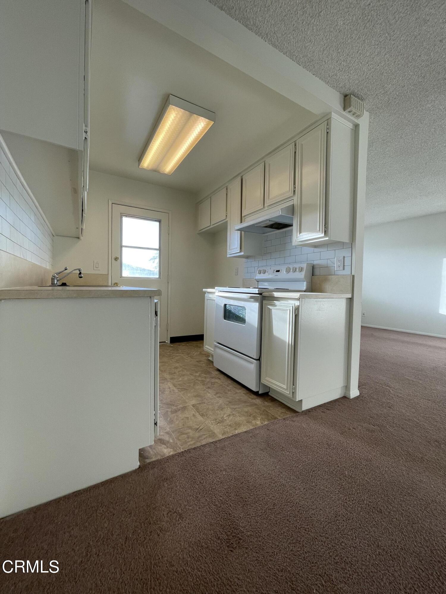 1103 Bryce Way Ventura, CA 93003 - Photo 4 of 8 a kitchen with stainless steel appliances a stove a sink a refrigerator and cabinets