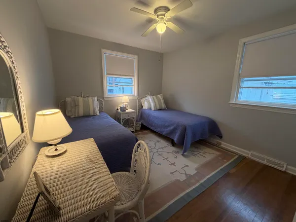 a bedroom with two beds and a window