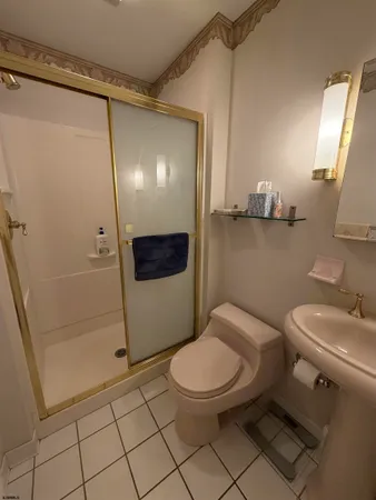 a bedroom with two beds and lamps