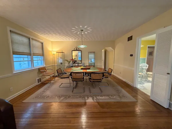 a living room with lots of furniture and a chandelier