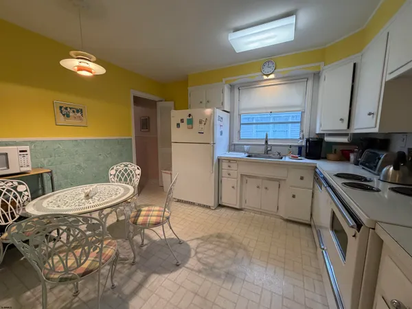 a bedroom with two beds and a dresser