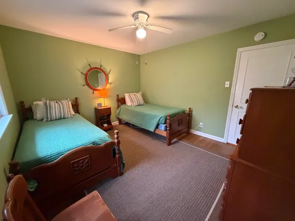 a bedroom with two beds and a chandelier