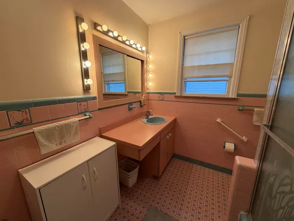 a bedroom with two beds and a window