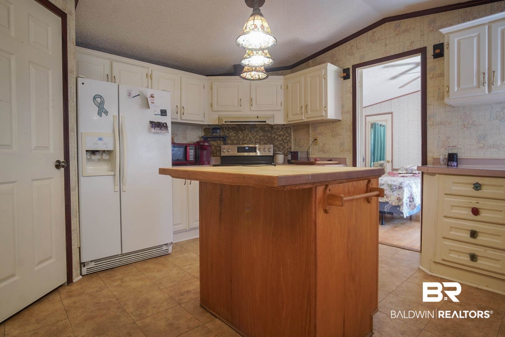 9190 County Road 97 Elberta, AL 36530 - Photo 20 of 53 Kitchen with light tile patterned flooring, stainless steel stove, tasteful backsplash, butcher block counters, and white refrigerator with ice dispenser