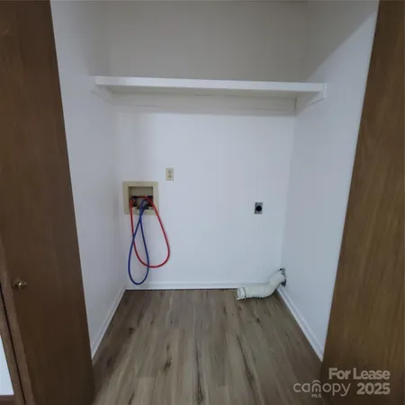 a view of a room with wooden floor