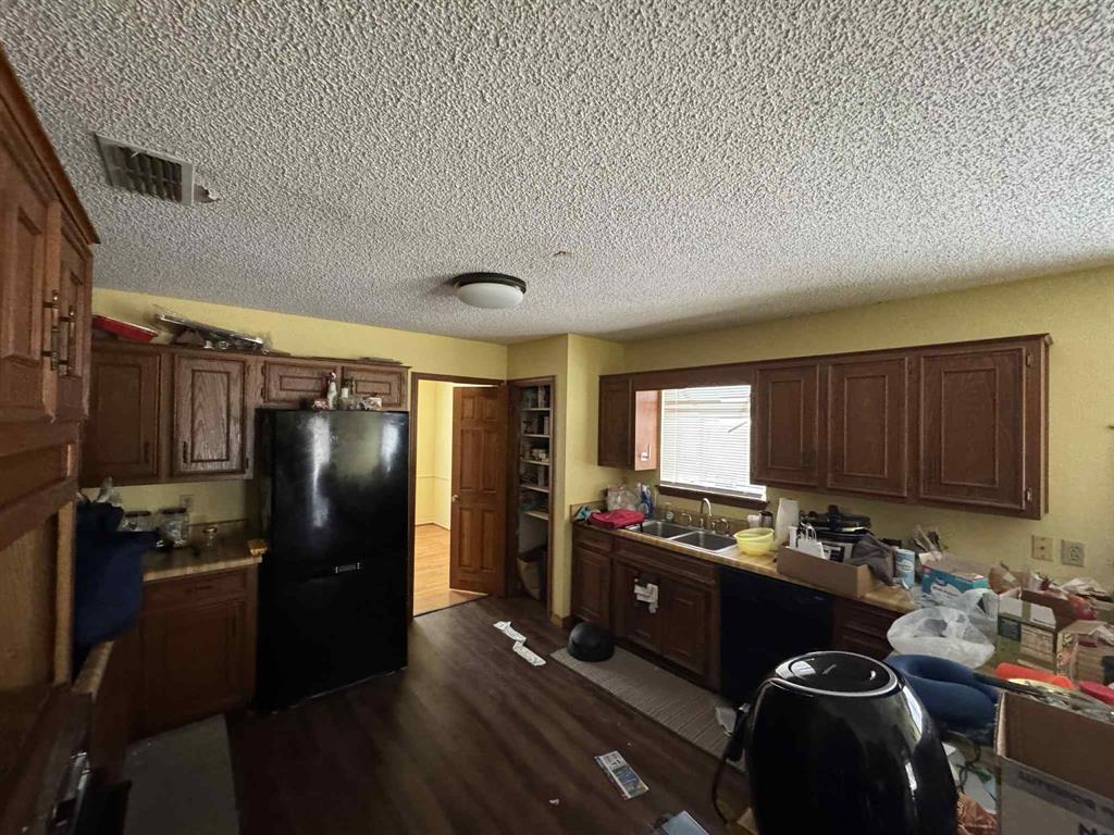 1316 Edna Street Commerce, TX 75428 - Photo 15 of 16 a kitchen with stainless steel appliances granite countertop a refrigerator stove and sink