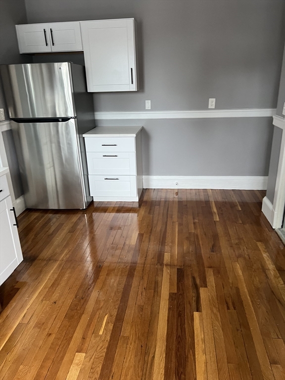 840 Massachusetts Avenue, Unit 8 Arlington, MA 02476 - Photo 2 of 8 a view of wooden floor in a kitchen