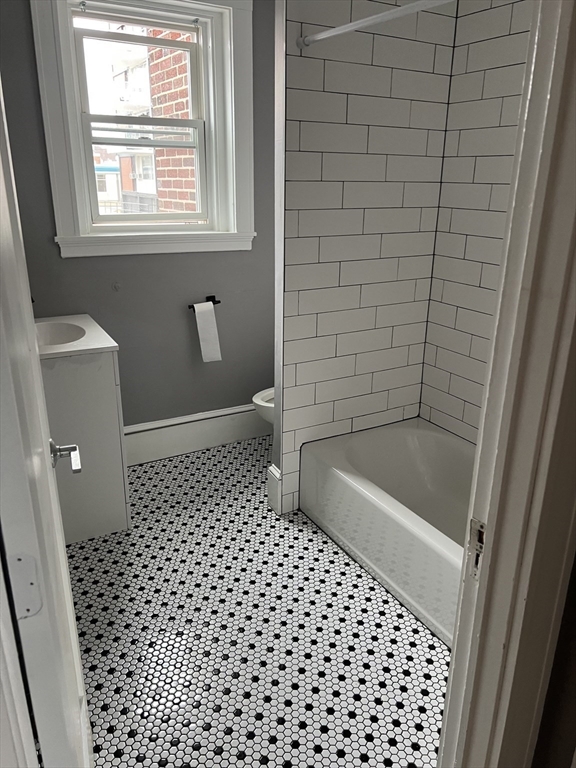 840 Massachusetts Avenue, Unit 8 Arlington, MA 02476 - Photo 5 of 8 a bathroom with a bathtub a toilet and a shower