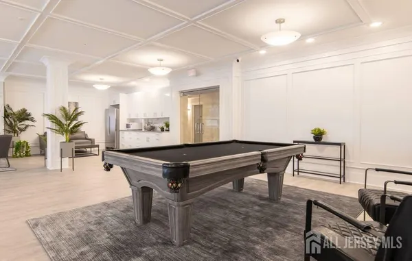 a room with pool table and windows