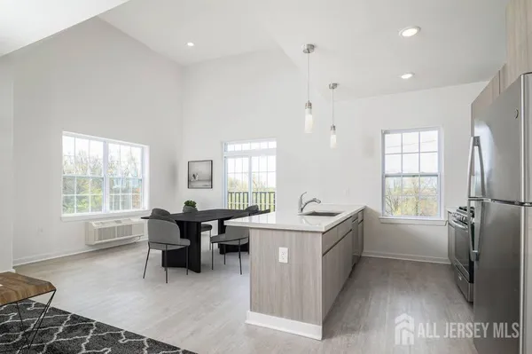 a kitchen with sink cabinets and refrigerator