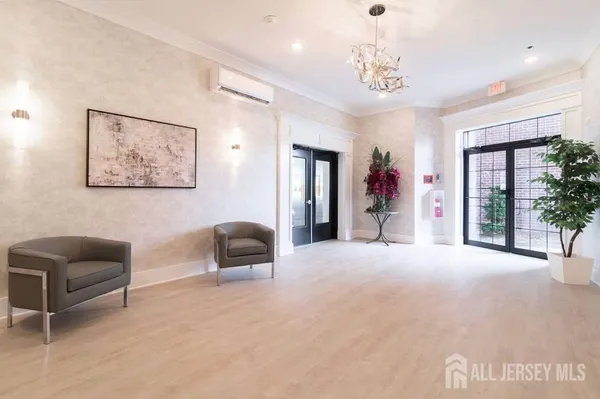 a living room with furniture and a chandelier