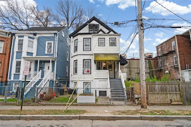 a front view of a residential apartment building with a yard