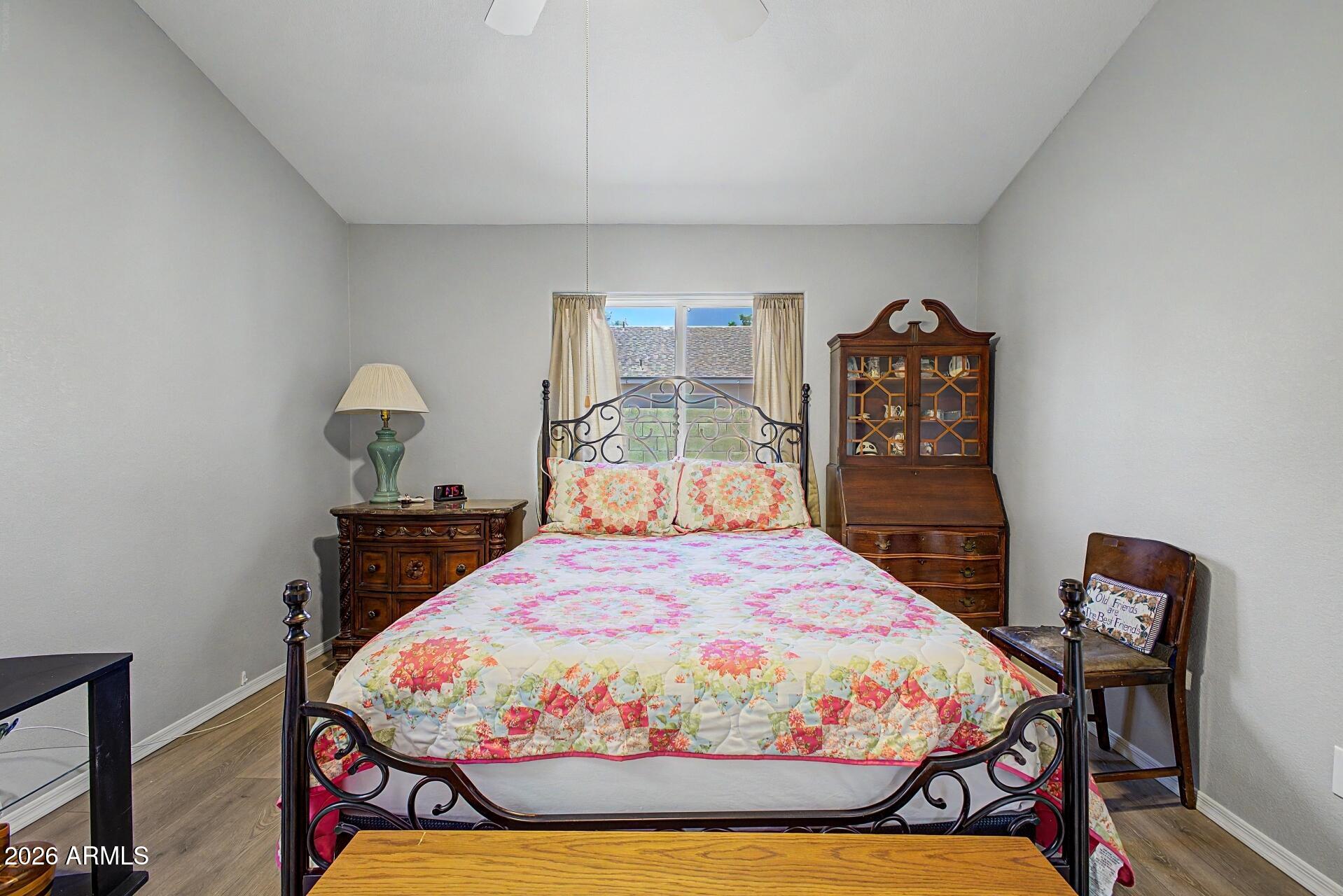 6335 East Brown Road, Unit 1144 Mesa, AZ 85205 - Photo 14 of 28 a bedroom with a bed and wooden floor