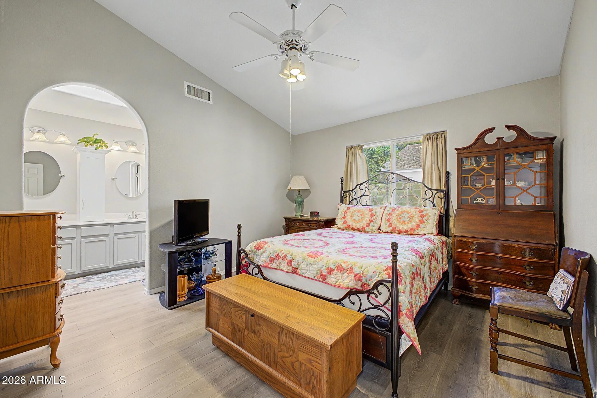 6335 East Brown Road, Unit 1144 Mesa, AZ 85205 - Photo 15 of 28 a bedroom with a bed dresser and a flat tv screen