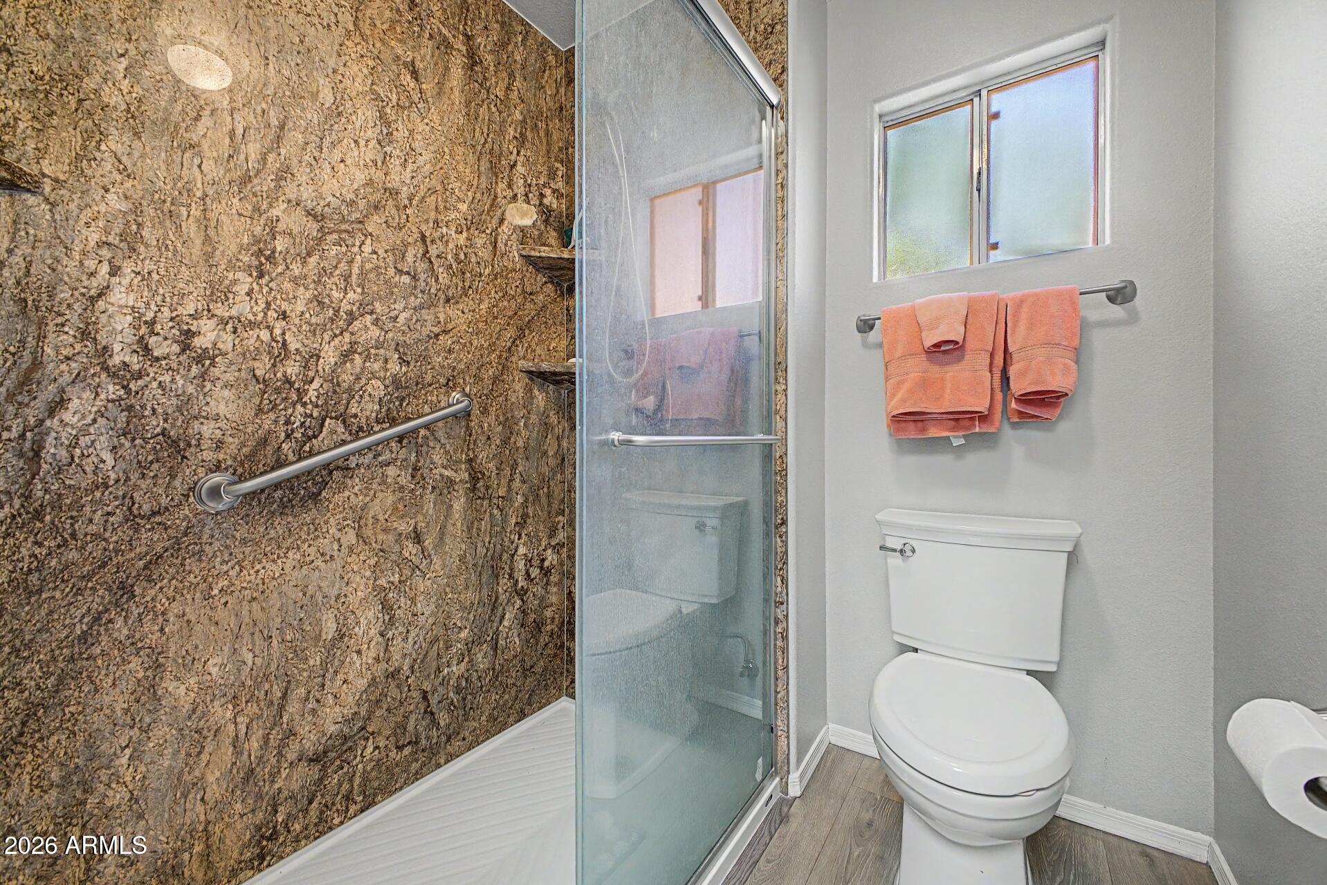 6335 East Brown Road, Unit 1144 Mesa, AZ 85205 - Photo 17 of 28 a bathroom with a toilet and a shower
