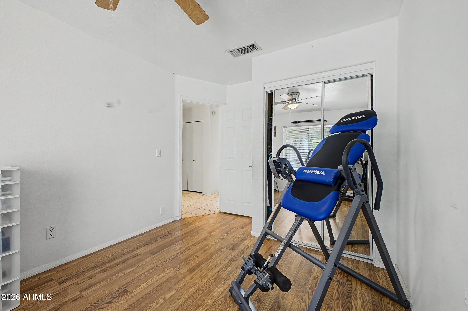 6335 East Brown Road, Unit 1144 Mesa, AZ 85205 - Photo 20 of 28 a view of workspace with wooden floor and lounge chair