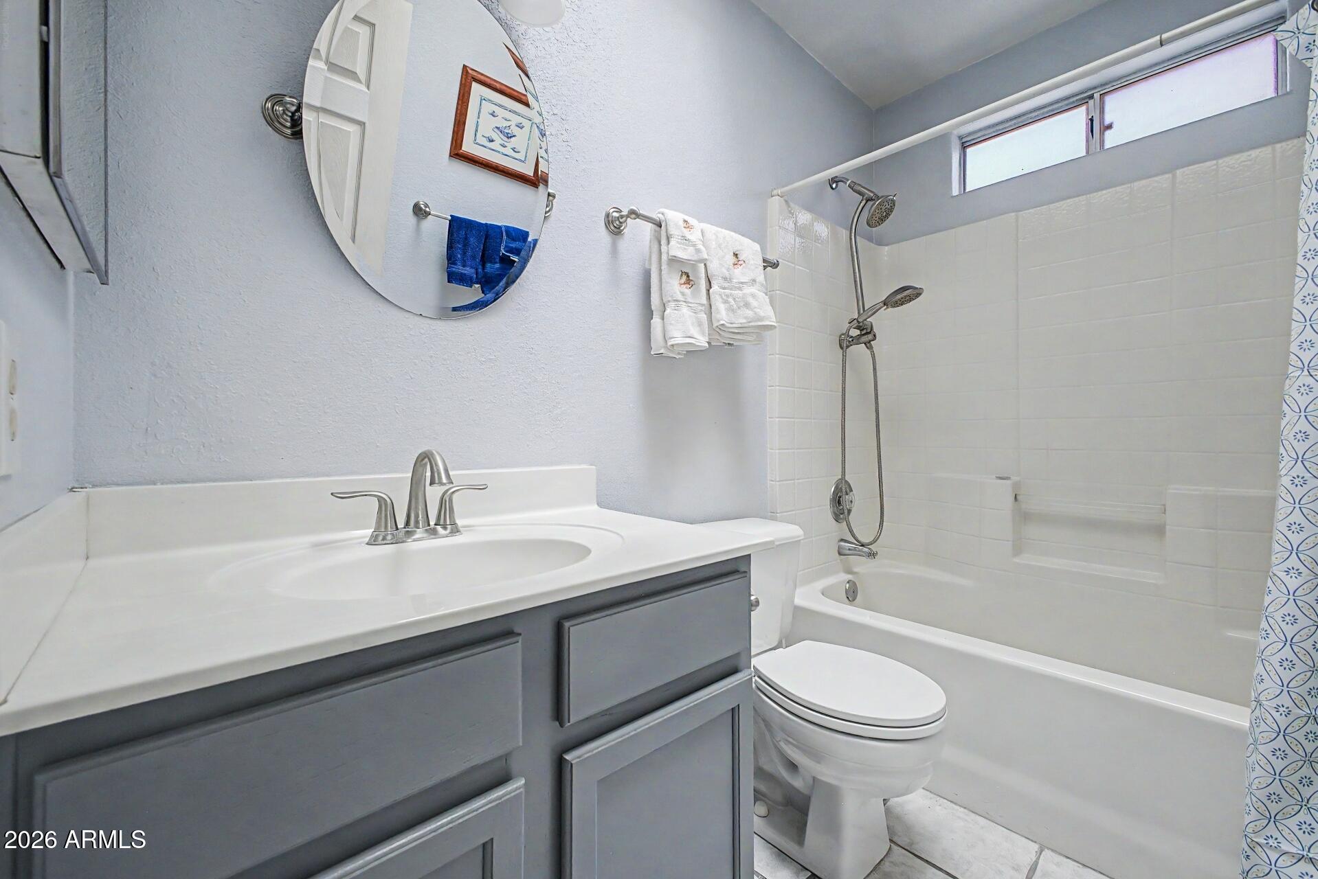 6335 East Brown Road, Unit 1144 Mesa, AZ 85205 - Photo 21 of 28 a bathroom with a sink a toilet and a bathtub