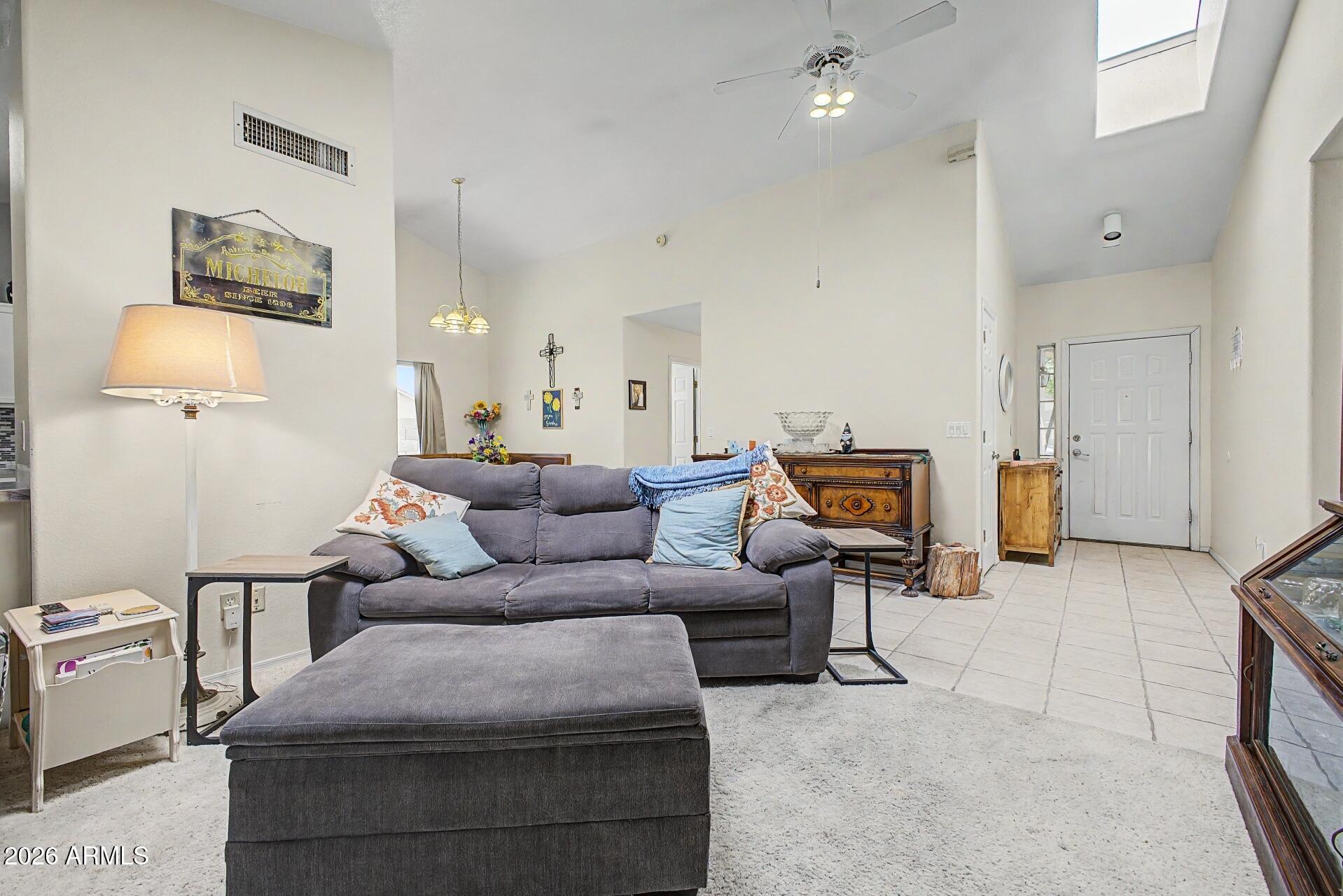 6335 East Brown Road, Unit 1144 Mesa, AZ 85205 - Photo 5 of 28 a living room with furniture and a lamp