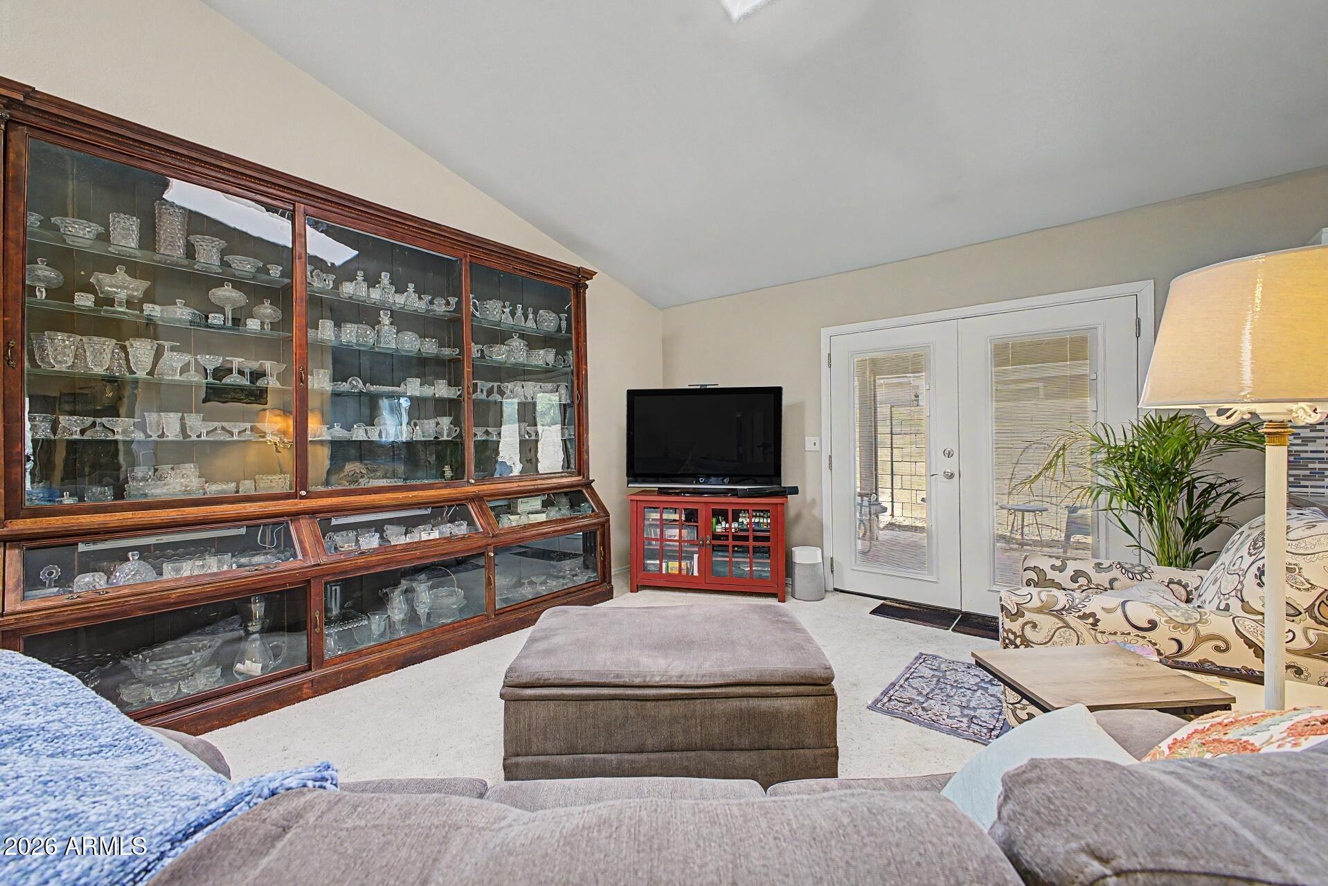 6335 East Brown Road, Unit 1144 Mesa, AZ 85205 - Photo 7 of 28 a living room with furniture and a flat screen tv