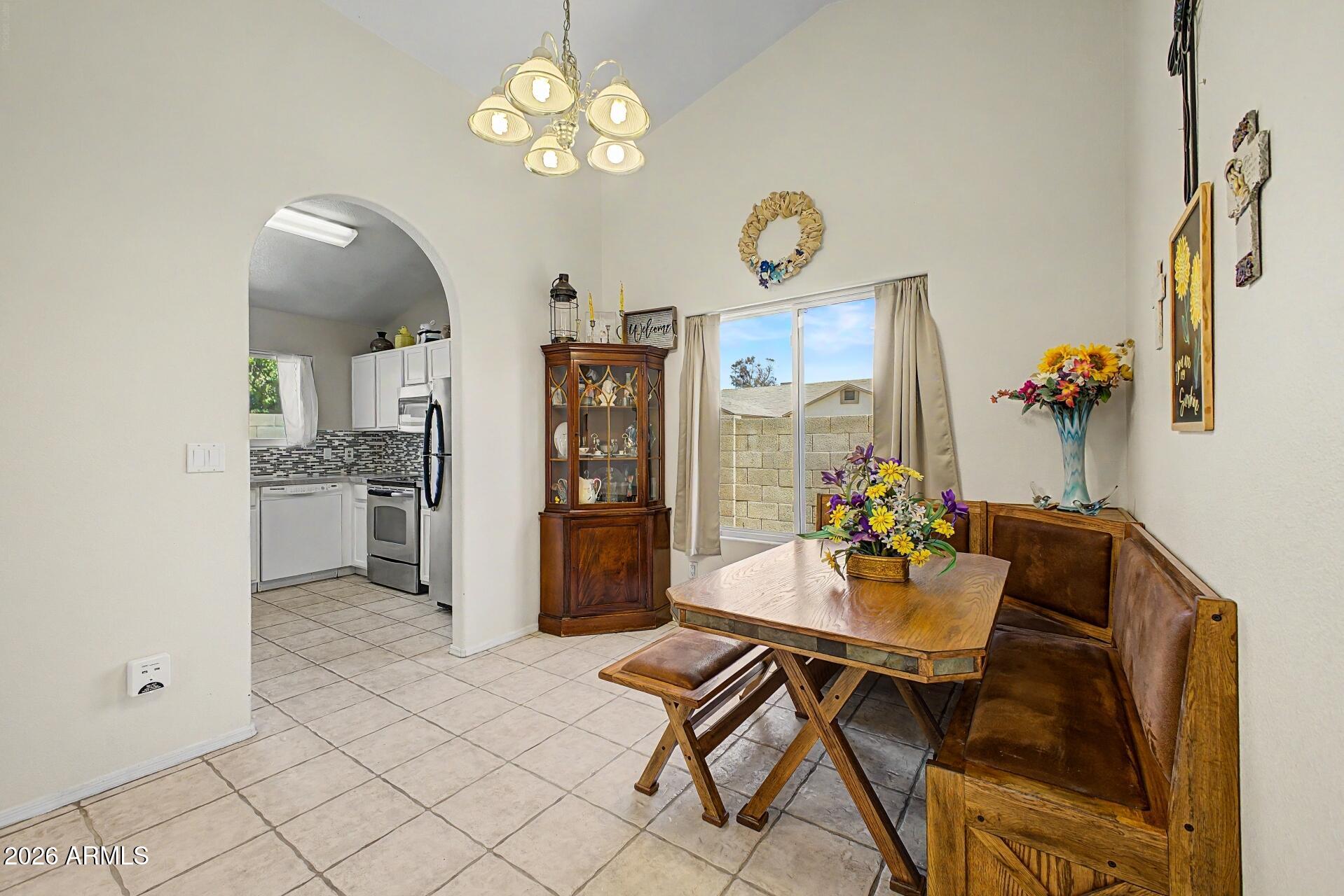 6335 East Brown Road, Unit 1144 Mesa, AZ 85205 - Photo 8 of 28 a view of a dining room with furniture and chandelier