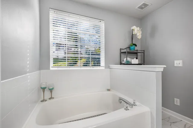 a bathroom with a double vanity sink mirror and shower