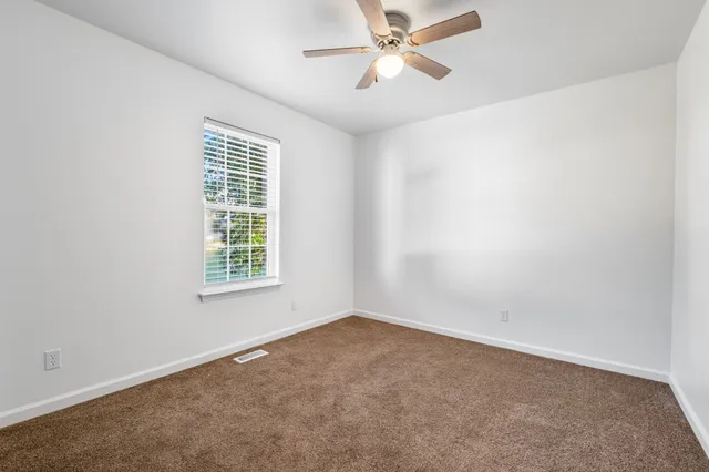 a view of an empty room with a chandelier