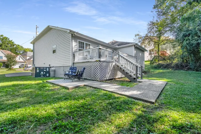 a view of a backyard with a large tree