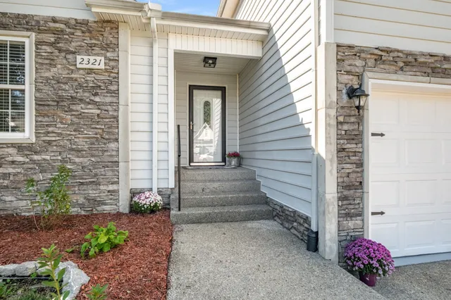 a view of a house with potted plants