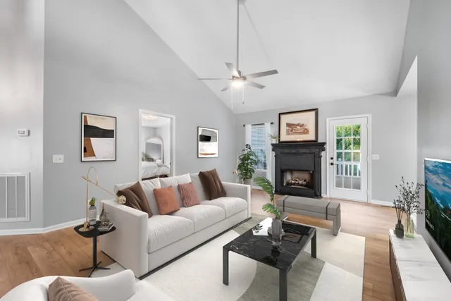 a living room with furniture a fireplace and a flat screen tv