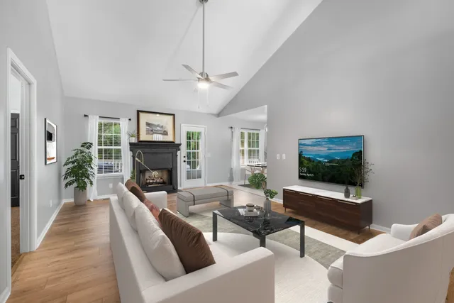 a living room with furniture a fireplace and a flat screen tv