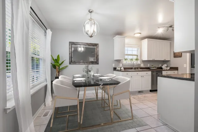 a kitchen with a dining table cabinets and appliances