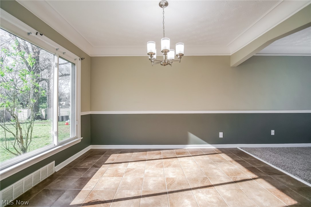 736 Quilliams Road Cleveland Heights, OH 44121 - Photo 7 of 20 Tiled spare room with a notable chandelier and radiator