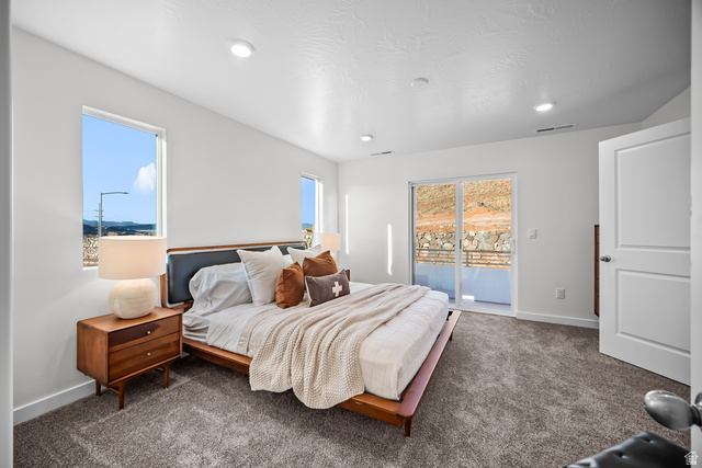 2202 Wolverine Way, Unit 2529 Washington, UT 84780 - Photo 20 of 27 Spacious room featuring broadloom carpeting, two windows, and a sliding glass door leading to a private outdoor space