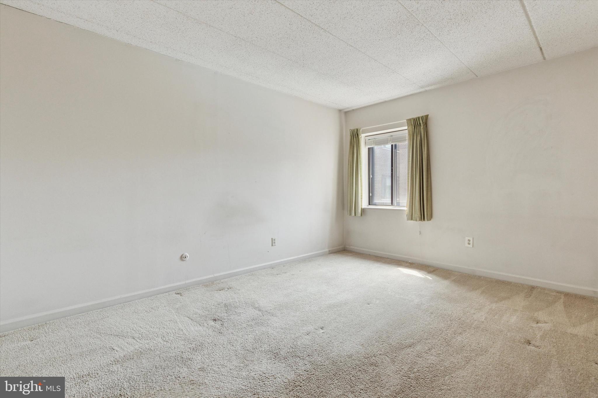 1219 West Wynnewood Road, Unit 400 Wynnewood, PA 19096 - Photo 12 of 15 a view of an empty room with a window
