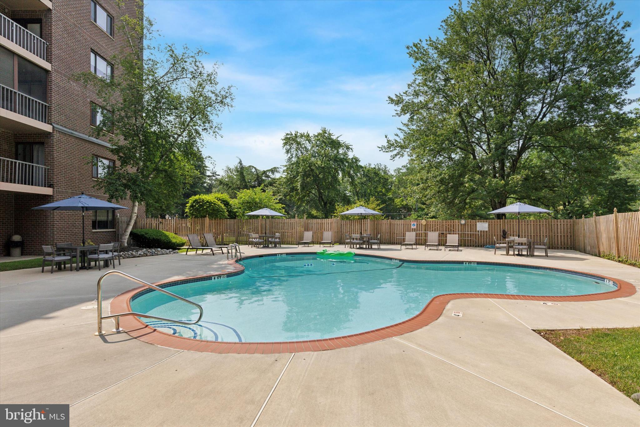 1219 West Wynnewood Road, Unit 400 Wynnewood, PA 19096 - Photo 15 of 15 a view of a swimming pool with a sitting space