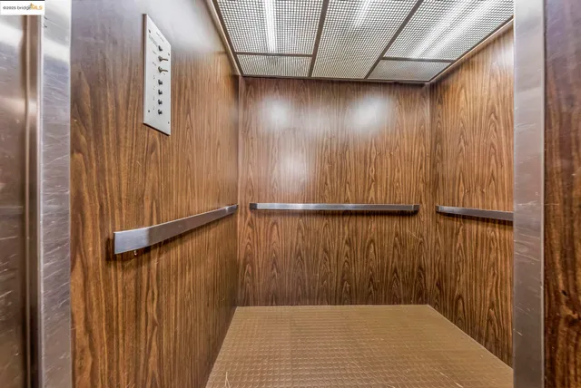 a view of empty room with wooden floor and fireplace