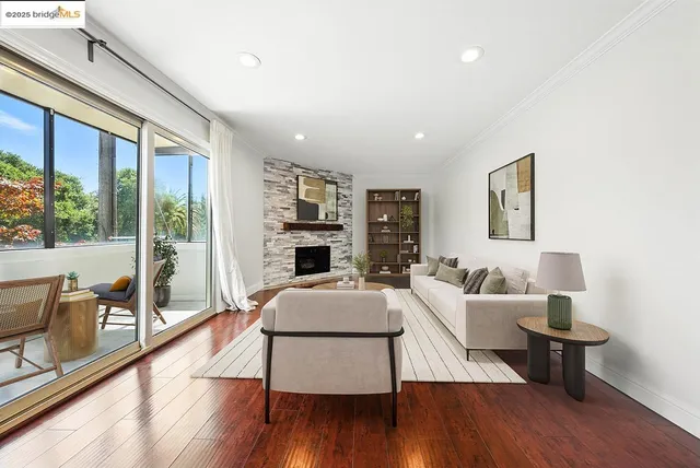 a living room with fireplace furniture and a large window