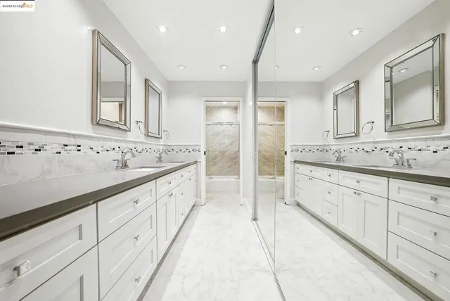 a utility room with dryer washer and a view of living room